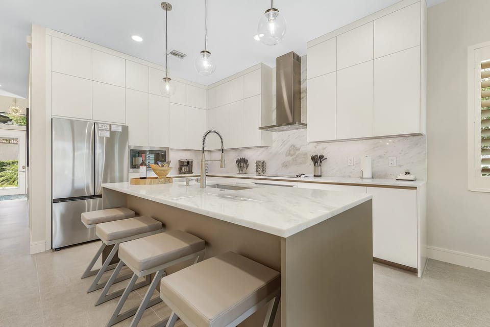 Marble kitchen island in the gorgeous chef's kitchen w/ custom Italian cabinets