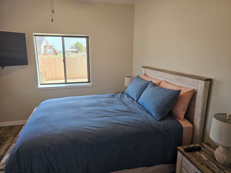 Bedroom with Solar Shades and TV.
