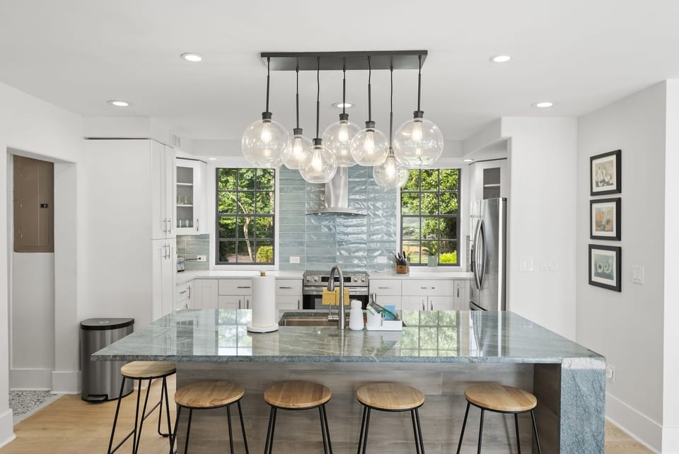 Gather around the stylish kitchen bar perfect for morning coffee, casual bites, or sharing drinks while the chef cooks.