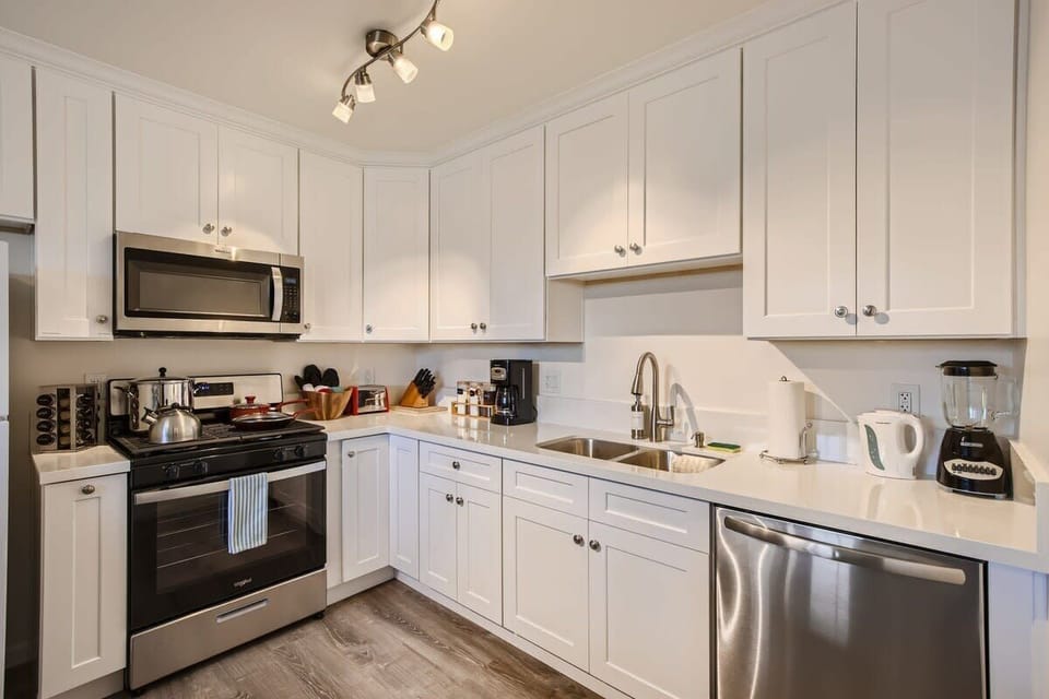 Enjoy the full kitchen and dining area with a refrigerator, freezer, oven, stove, microwave, dishwasher, coffee, creamers, mixers, spices, pots, pans, cooking supplies, cutlery, cups, plates, bowls, utensils, small appliances, and many more essentials.