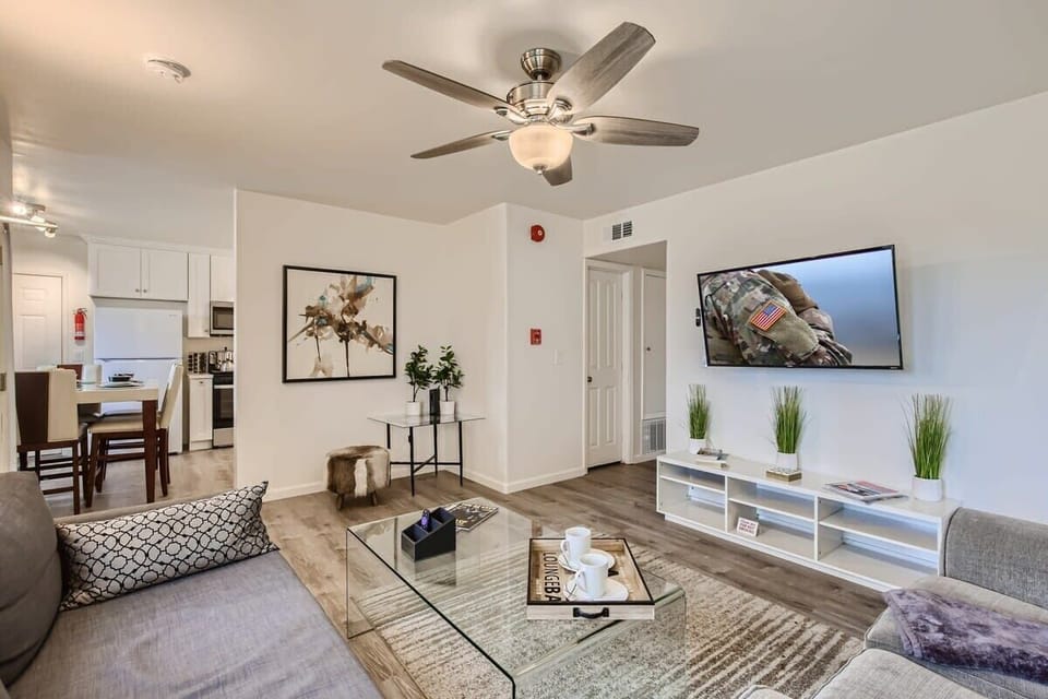 Walk into a Sophisticated living room design with two sofas that open up to full-size beds, 60” Smart TV, full-length mirrors, beautiful decor, and much more.