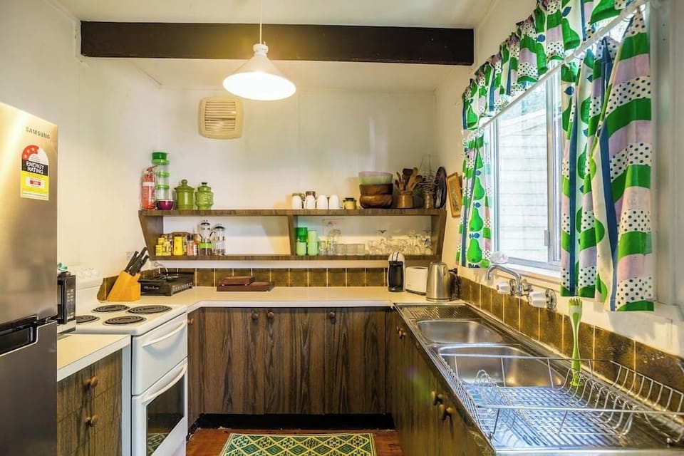 Fully equipped kitchen with electric stove, microwave, gas BBQ on back deck