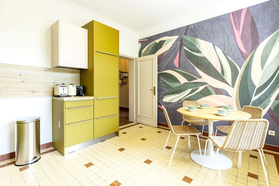Colorful breakfast nook with artistic wall decor and a cozy dining table, perfect for enjoying your morning meals.