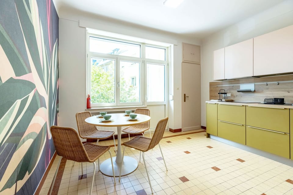 Bright and cheery kitchen with modern appliances and a charming dining area, ideal for family meals and casual dining.
