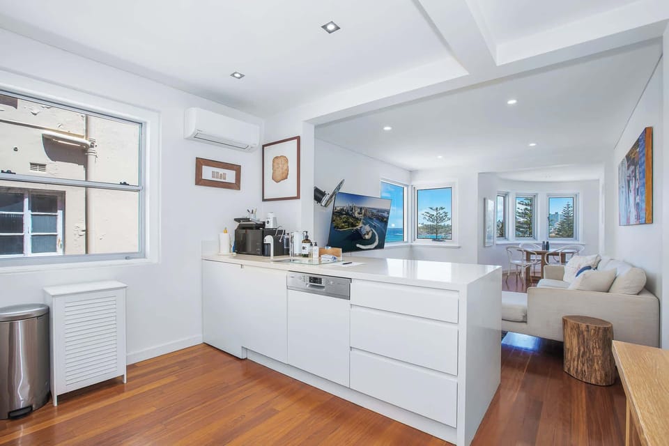 Open plan living space with kitchen island overlooking beautiful Bondi Beach