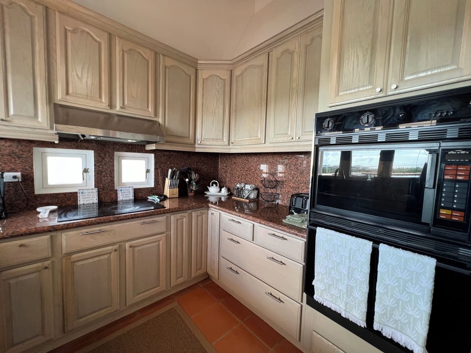 Oven, microwave, toaster, knives, coffee maker. 