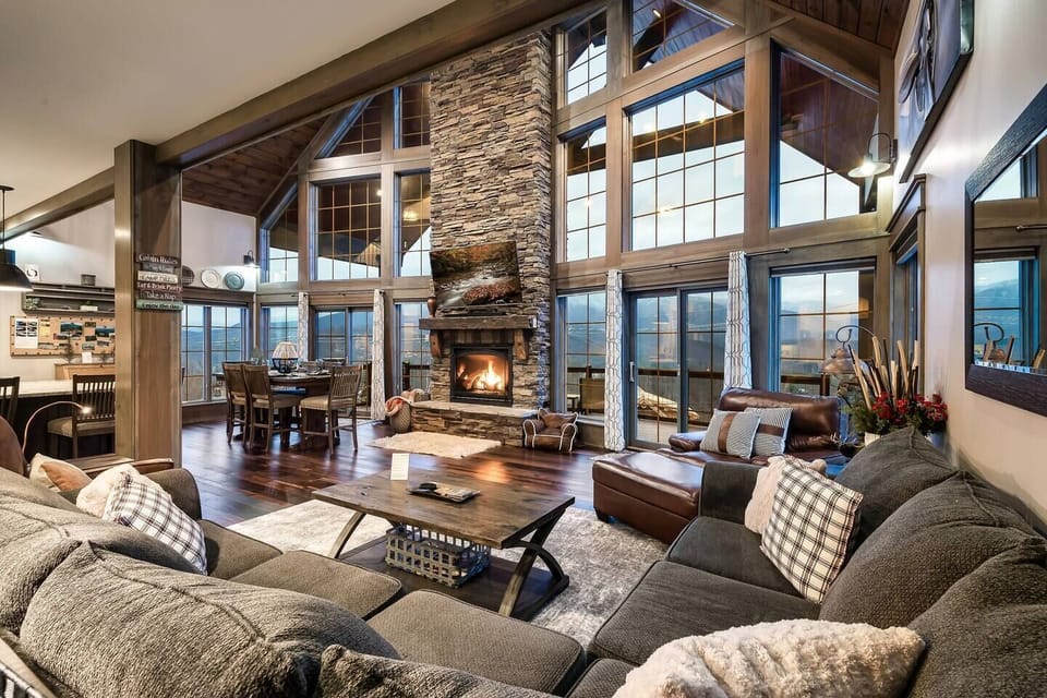 This stunning living room features towering windows and a cozy fireplace, creating the perfect blend of warmth and elegance.