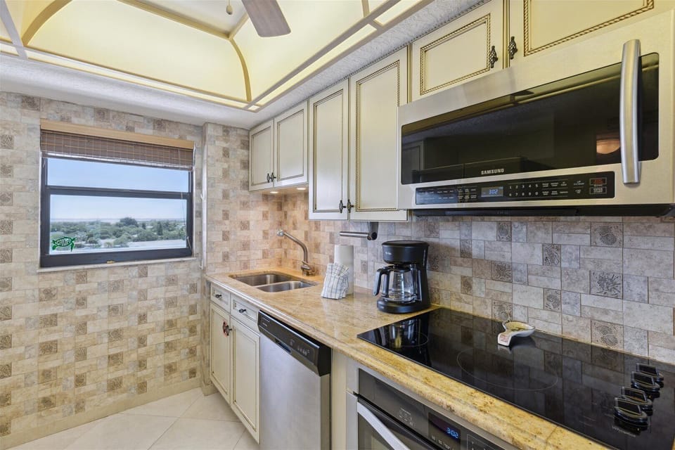 Well-equipped kitchen with modern appliances and a charming backsplash