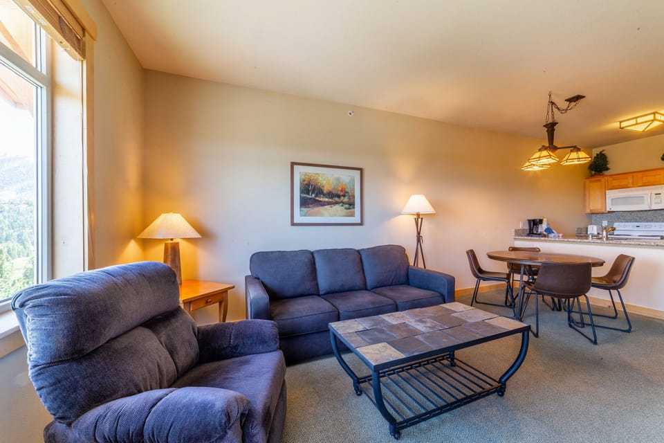Living room has queen sized sleeper sofa.