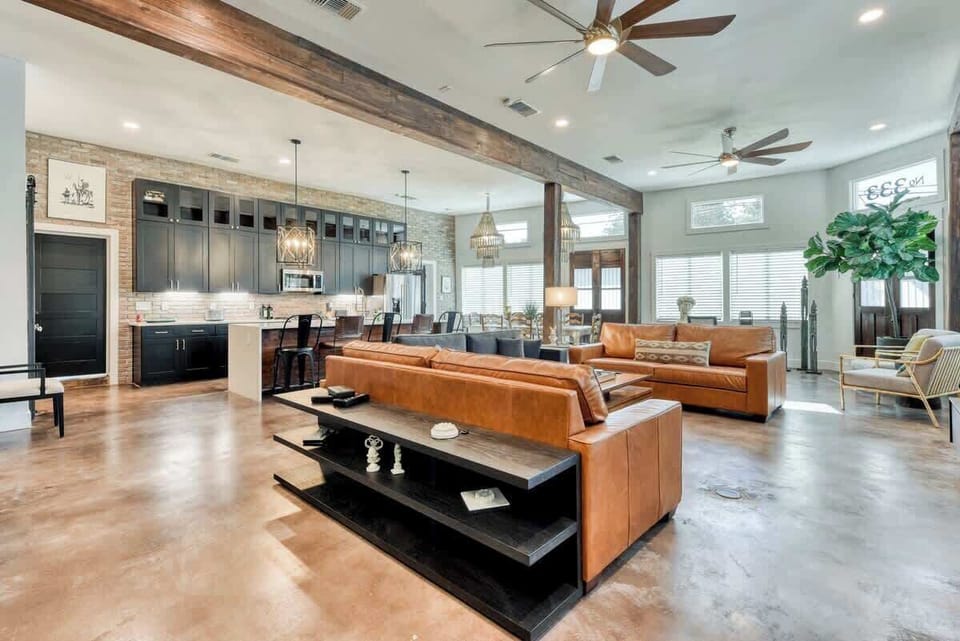 Sadie Street Living room is open to Kitchen and Dining with large windows and abundant natural light