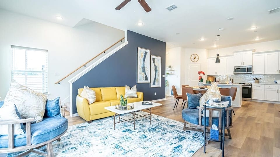 Enjoy a bright and comfortable living room with modern furnishings and cozy seating, the perfect place to unwind after exploring Arlington's entertainment district.