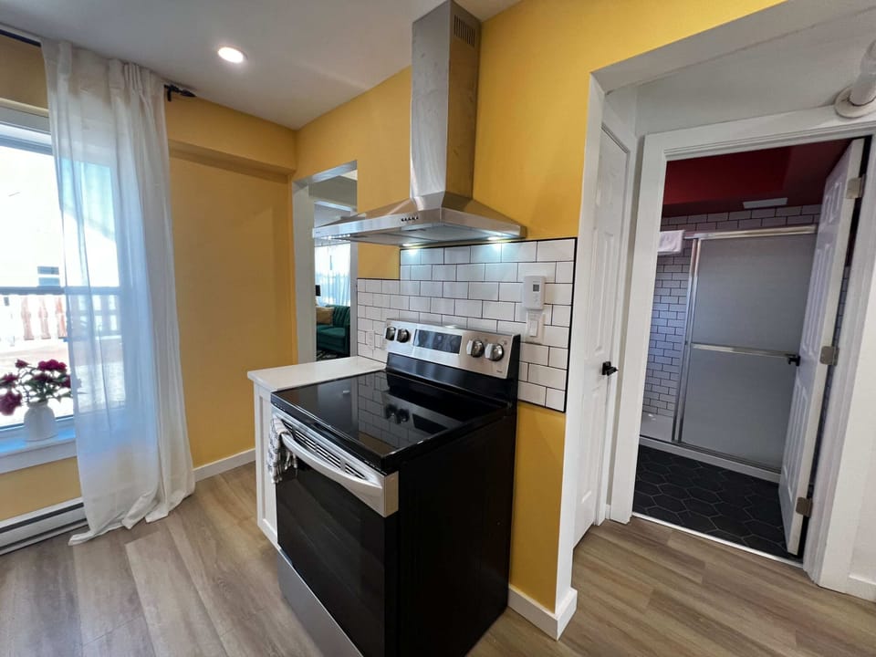 Bright, cheerful kitchen with yellow walls and everything you need to cook like home!