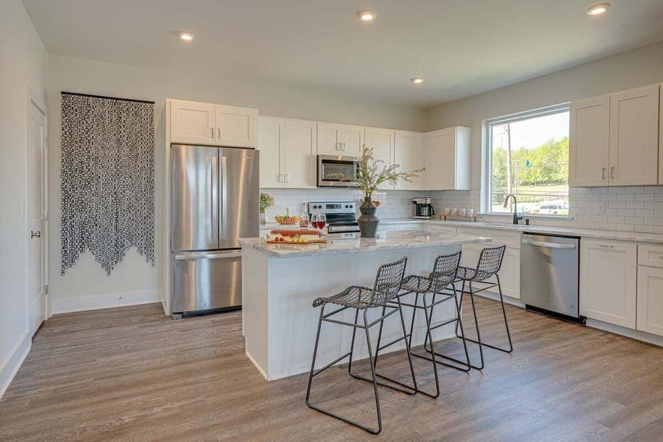 Fully equipped kitchen stocked with basic cooking essentials and stainless steel appliances.