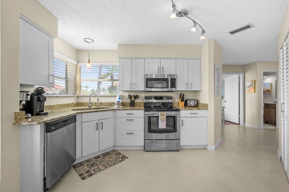 Fully equipped kitchen with stainless steel appliances, granite countertops, and all the essentials