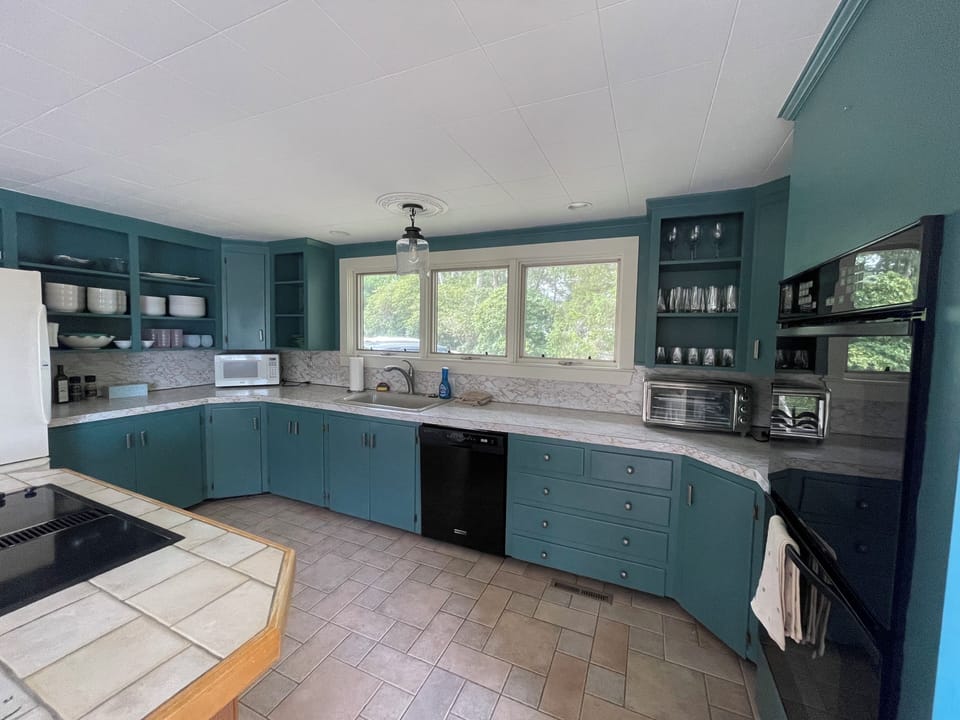 Kitchen stocked with new dishes, glasses, toaster/air fryer, and more