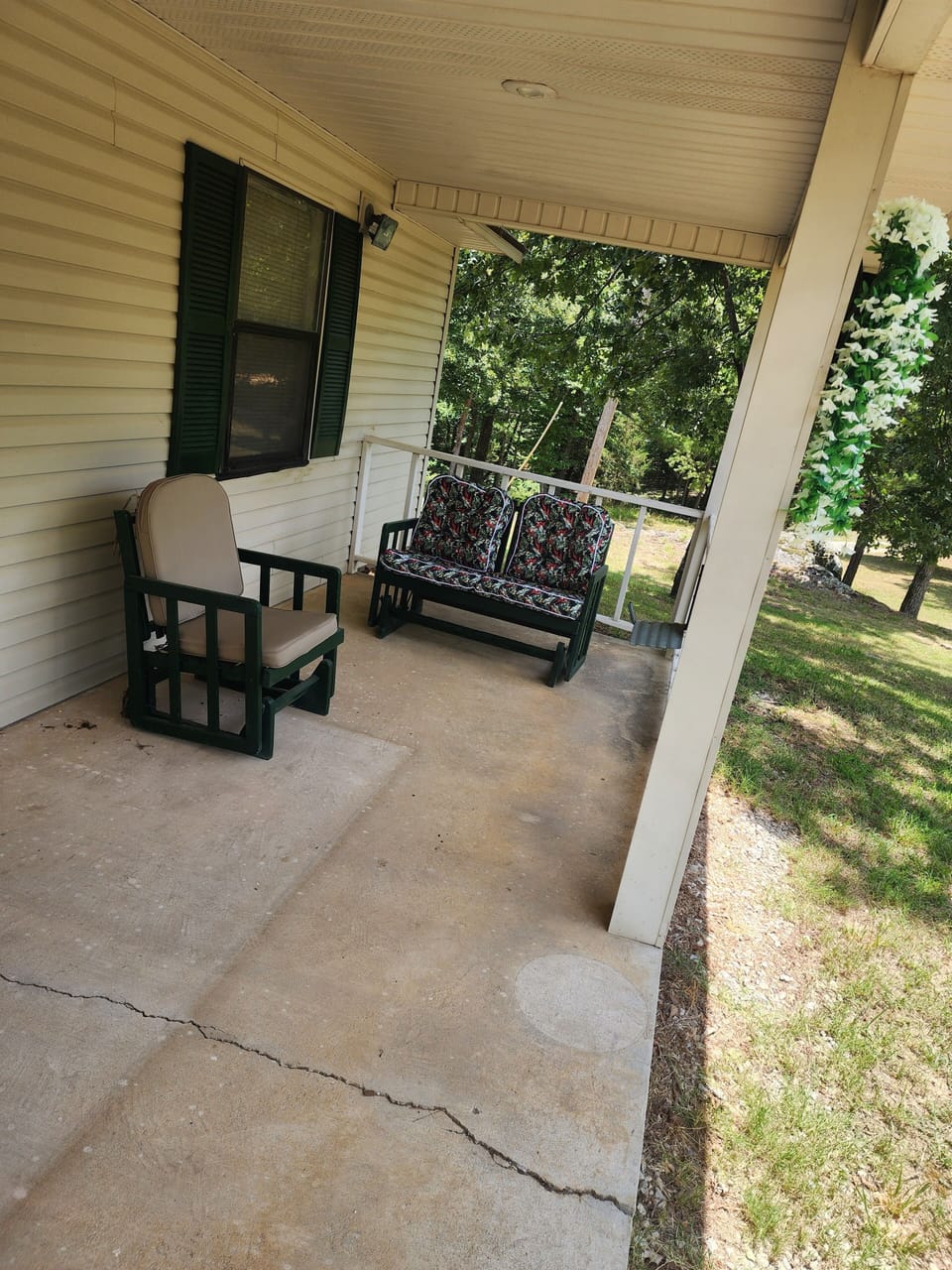 Left hand side of front porch. 