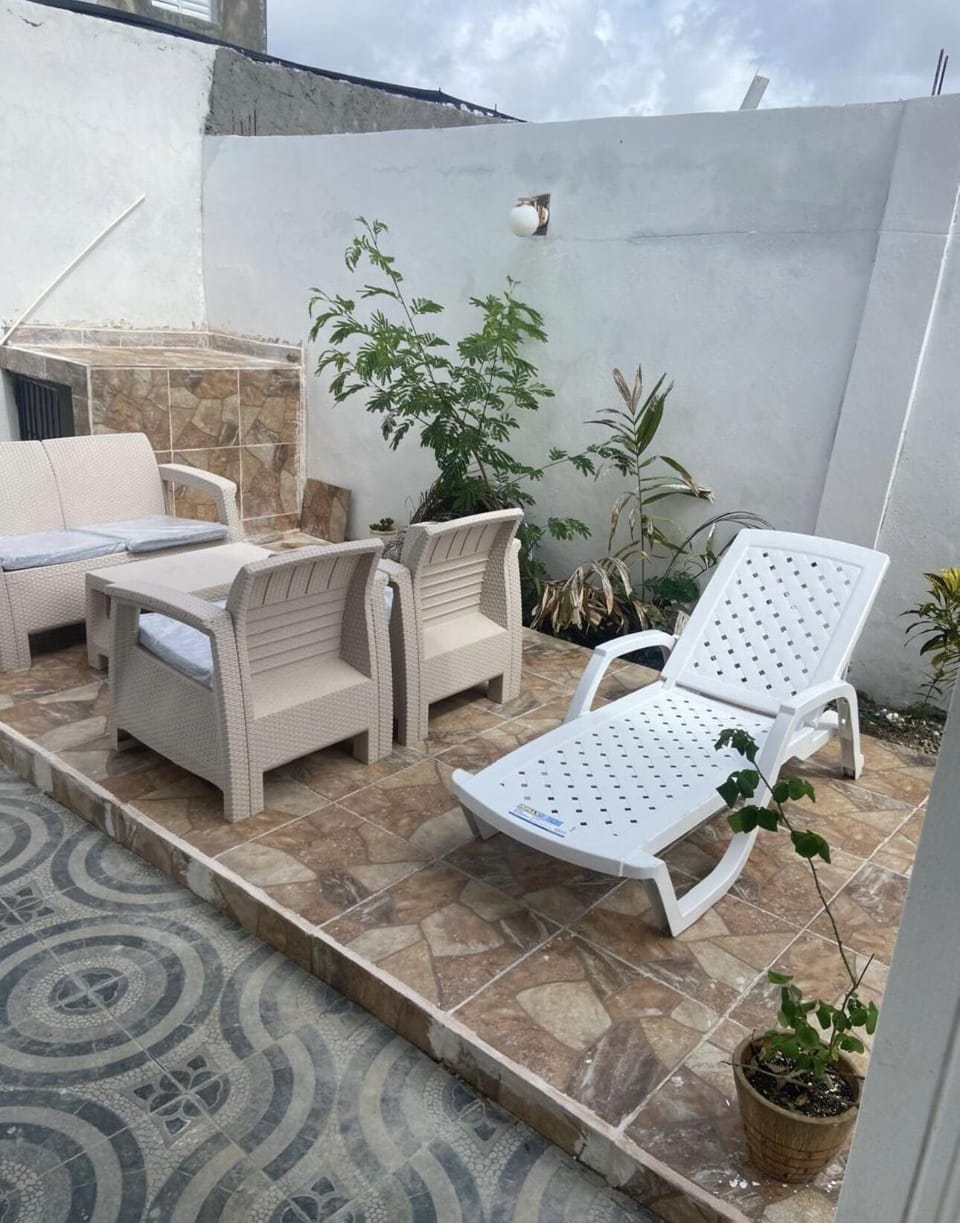Patio with a jacuzzi and BBQ area with a grill