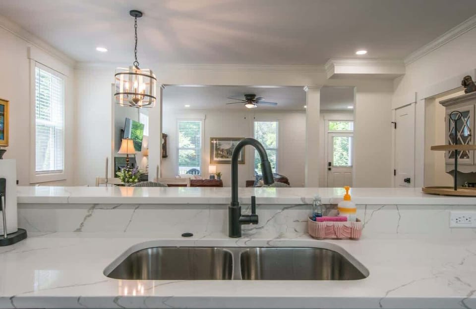 Kitchen sink view into the living room.