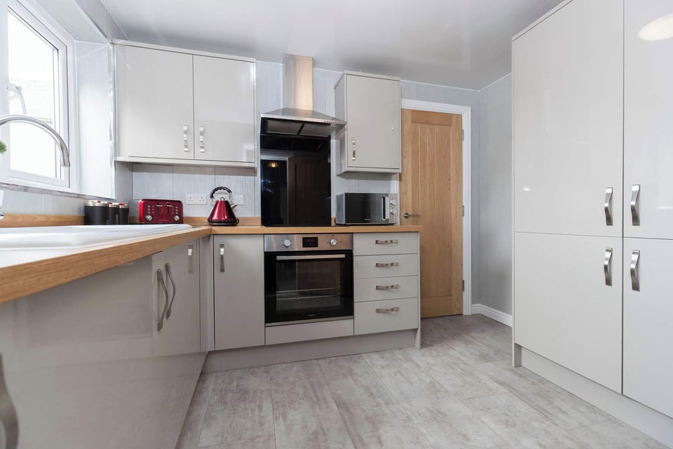 Kitchen on the first floor next to bathroom and dining room