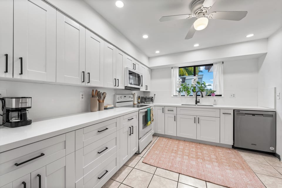 Kitchen with ample counter spaces, cupboards, and ceiling fan
