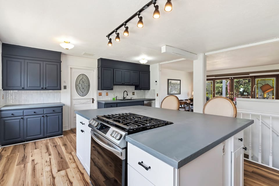 Open plan kitchen that leads to dining and outdoor patio