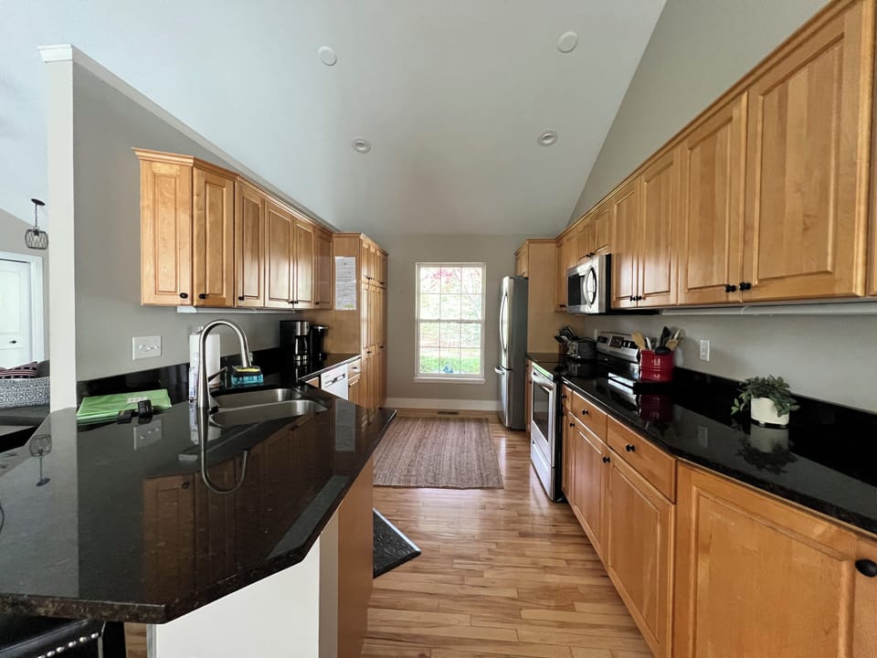 Fully equipped kitchen with dish washer, stove, oven, refrigerator, and more