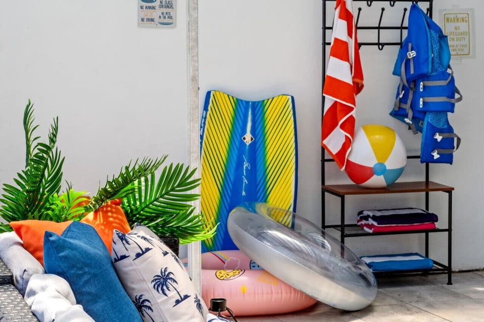 Beach essentials ready for your Miami adventure! Vibrant pool floats, cozy beach towels, and life vests.