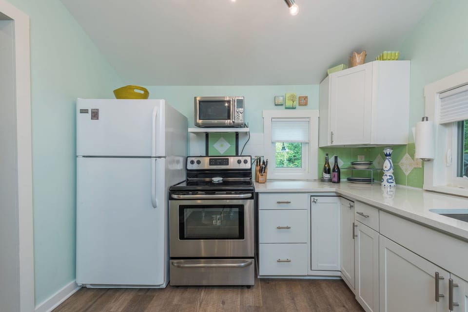 Kitchen with dishwasher, Drip-style coffee maker, and bar seating for two.