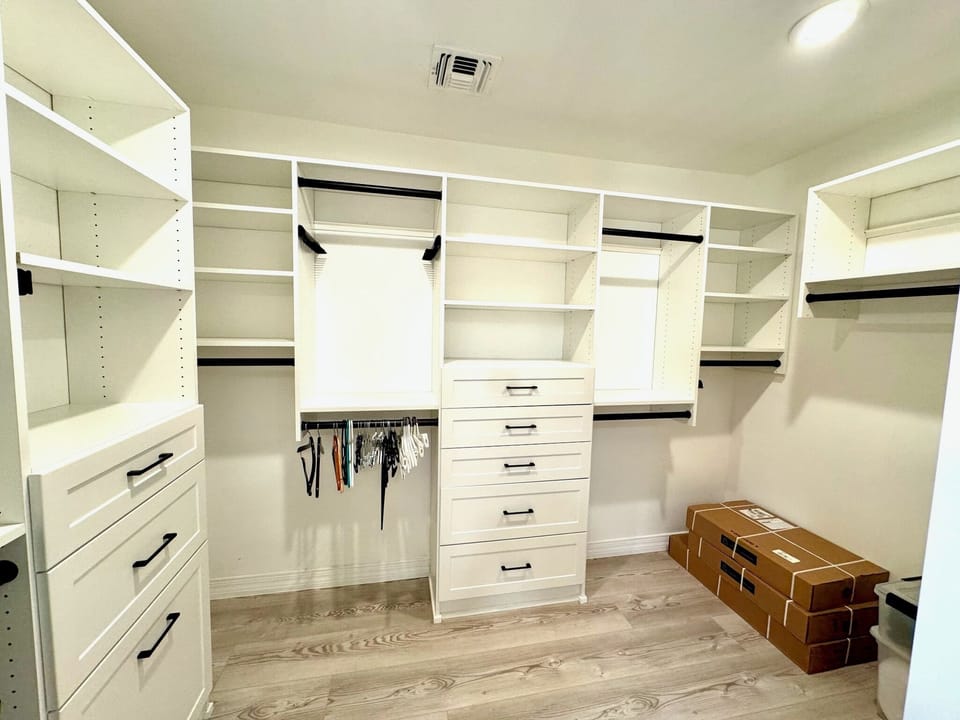 Primary Bedroom walk-in closet with closet organizers