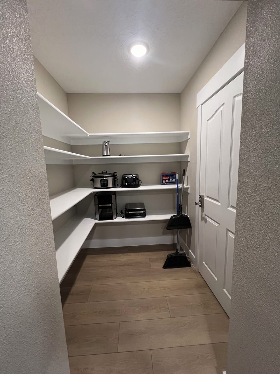 Open pantry: air fryer, crockpot, George Forman grill, toaster, and can opener.