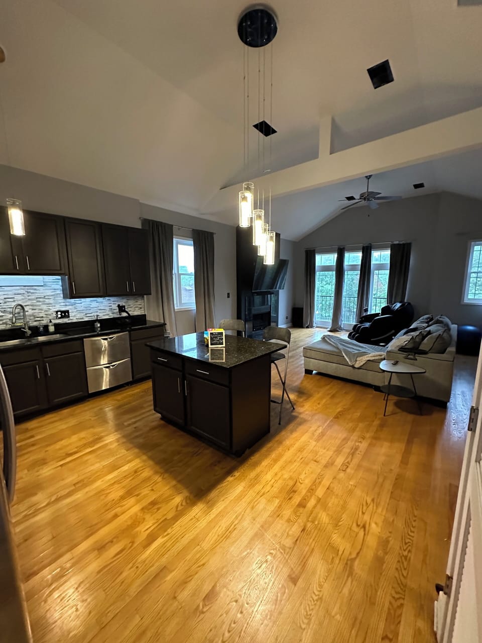 Open kitchen features stainless steel appliances.
