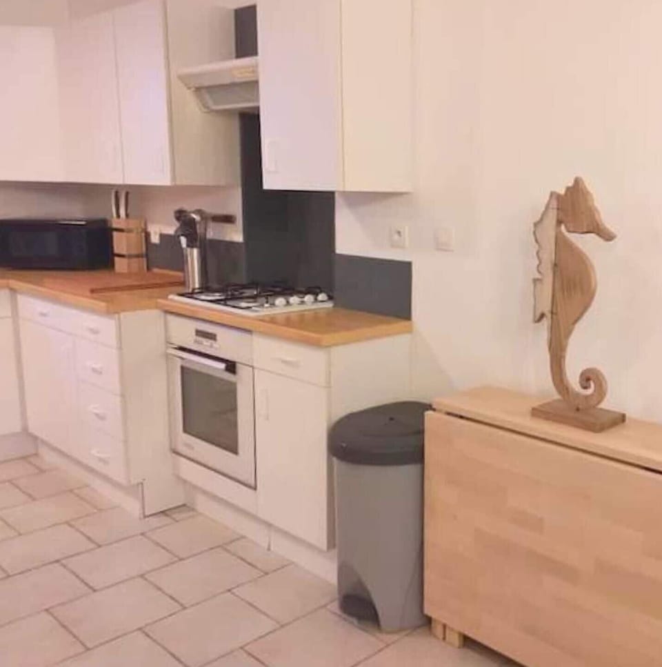 Large kitchen opening onto the living room, fully equipped