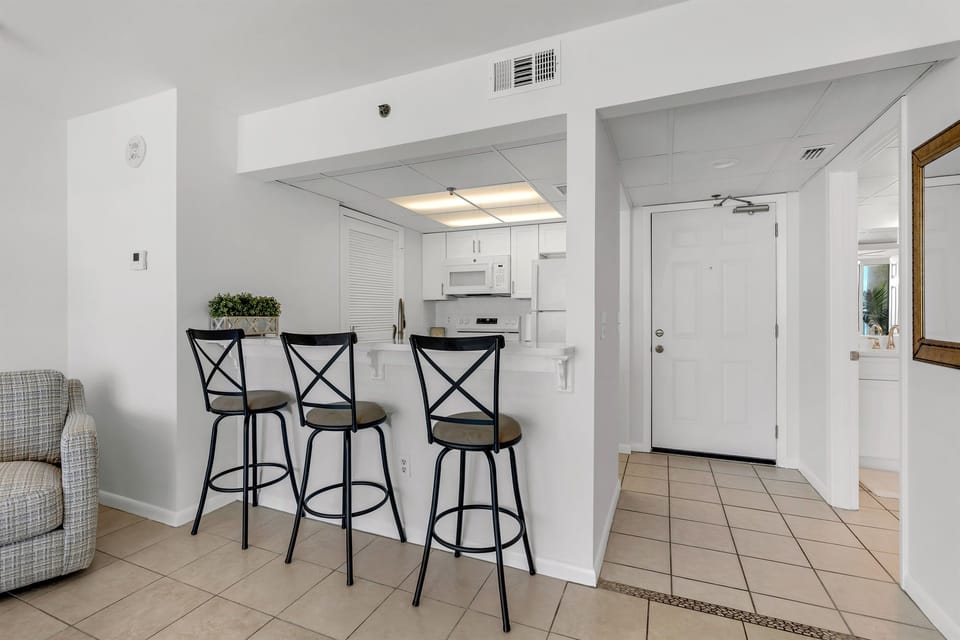 Gather around your breakfast bar for casual meals and conversations in this bright, open living space.
