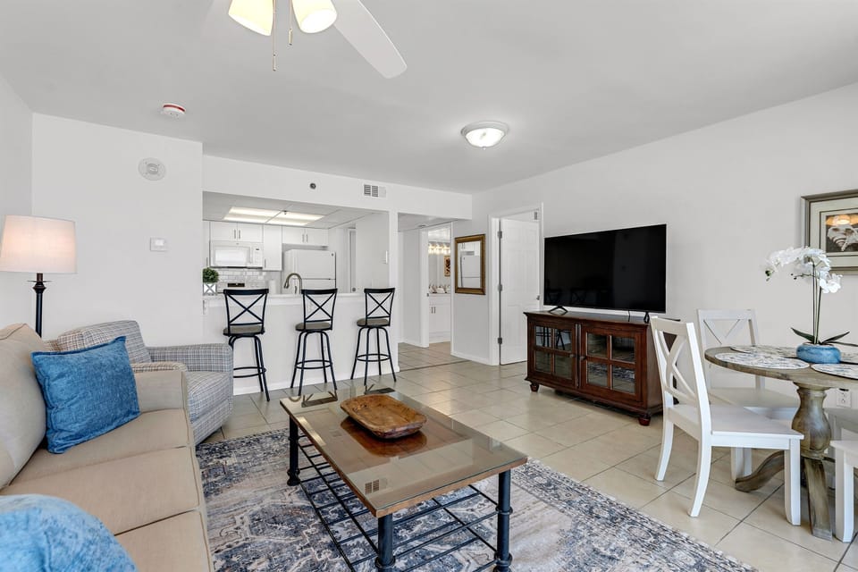 Unwind in your open-concept haven with comfortable seating, modern kitchen, and entertainment center for memorable evenings.
