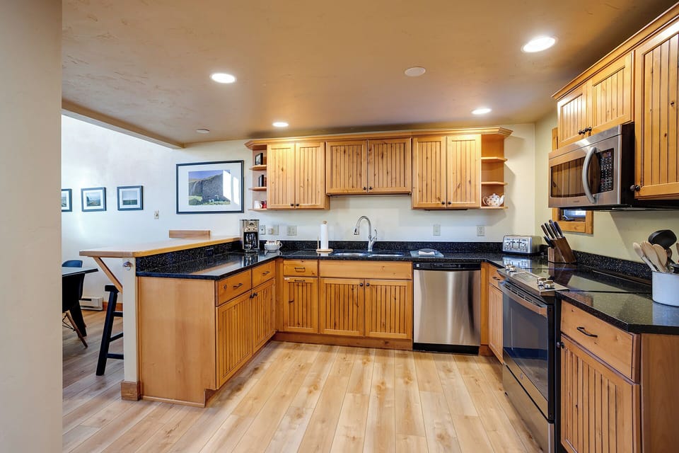 Your fully equipped kitchen features warm wood cabinetry, granite countertops, and stainless steel appliances—perfect for preparing memorable meals together.