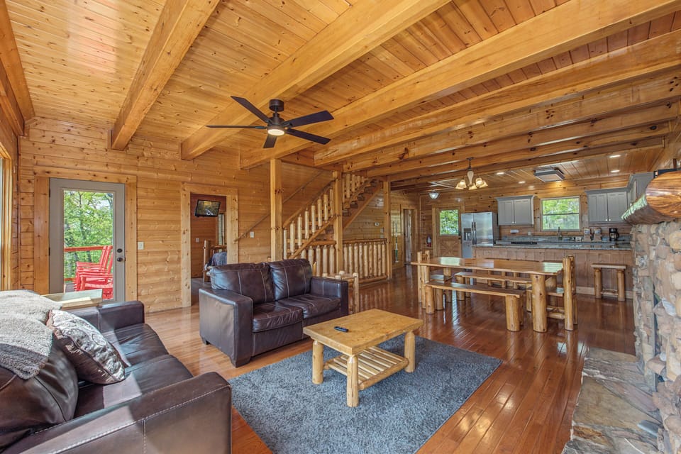 Relax in this stunning log cabin with exposed beams, leather seating, and open-plan design connecting living and kitchen spaces perfectly.