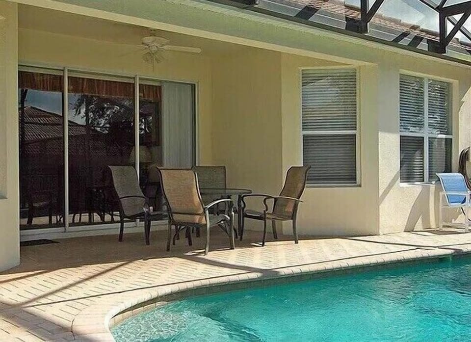 Private patio by the pool, perfect for enjoying outdoor meals or lounging in the sun.