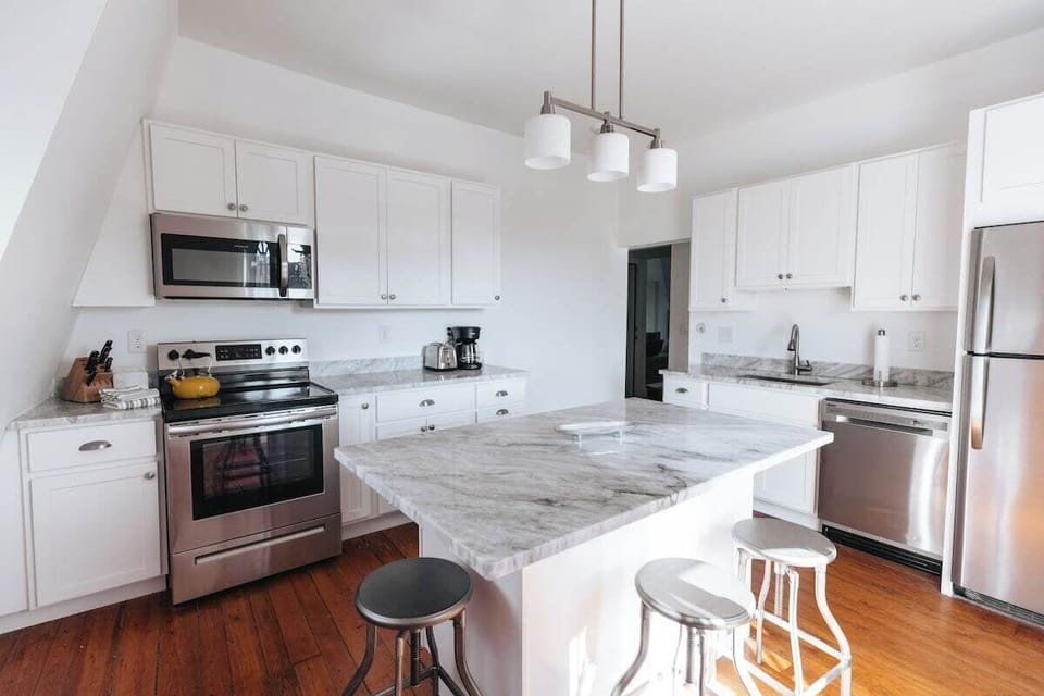 Kitchen with marble counter and deck access
