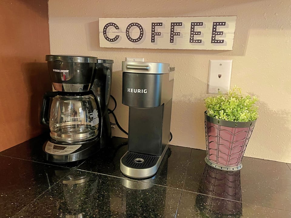 Coffee bar with pod coffee maker and drip coffee maker.