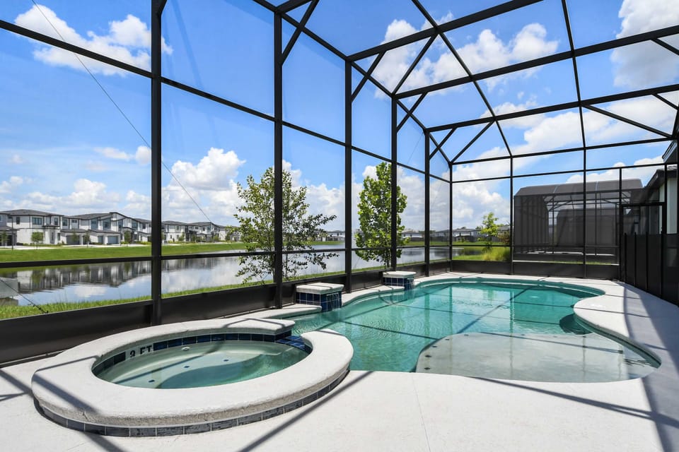 Screened-in pool and spa with serene lake views—your private paradise awaits.