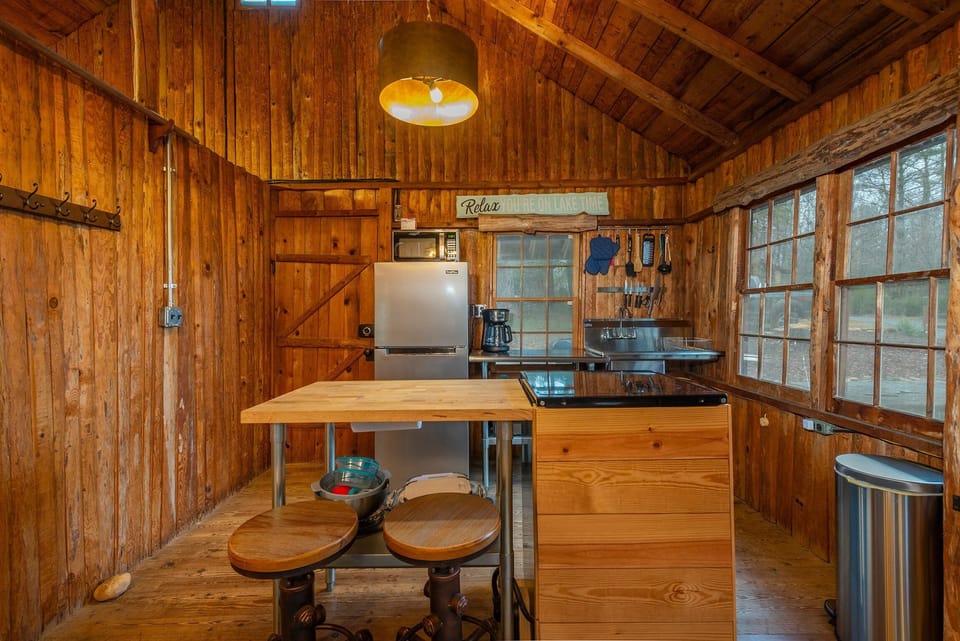 Kitchen with drip-style coffee pot and island seating for 2