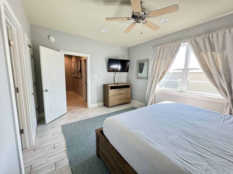 This bedroom is furnished with a king bed and a Smart TV. It has an ensuite bathroom.