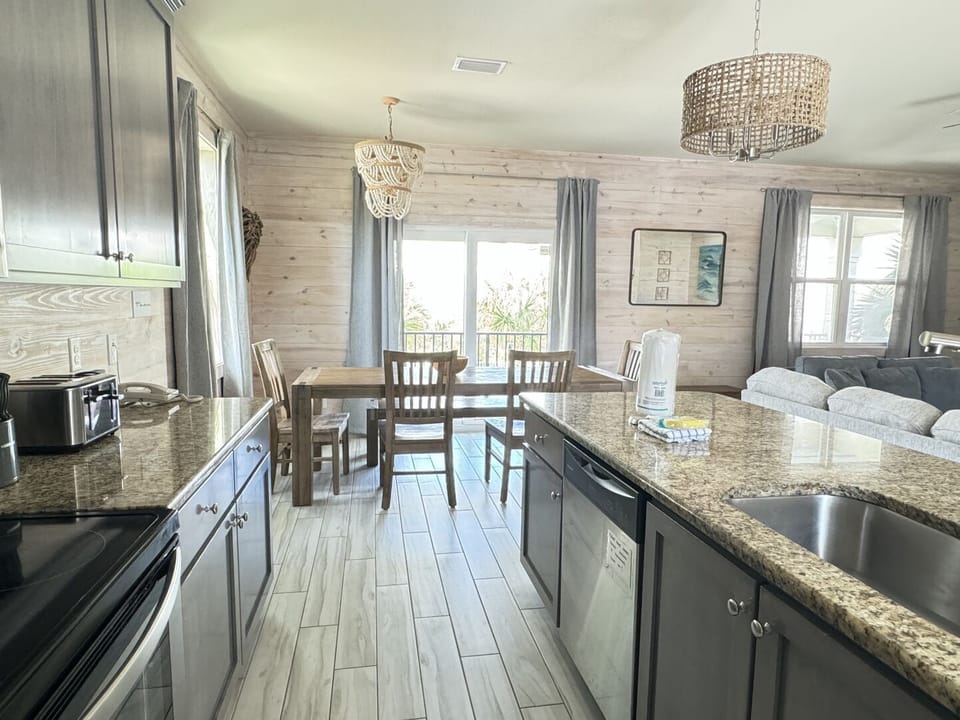 This home has an open floor plan that connects the living room, dining room, and kitchen.