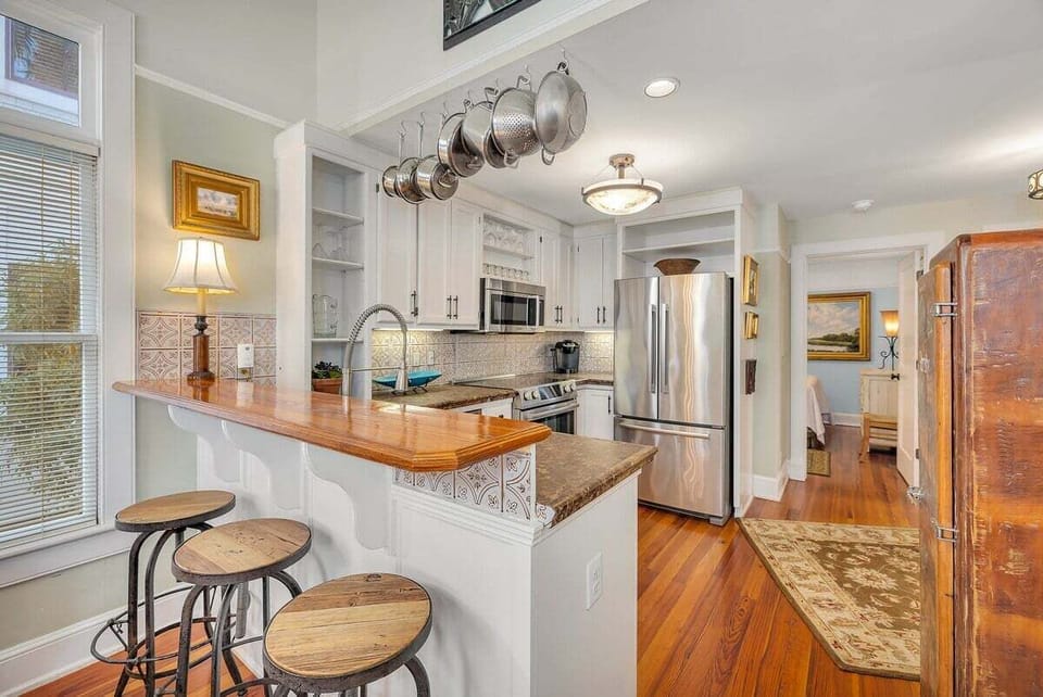 Open-concept kitchen with stainless steel appliances and peninsula with seating