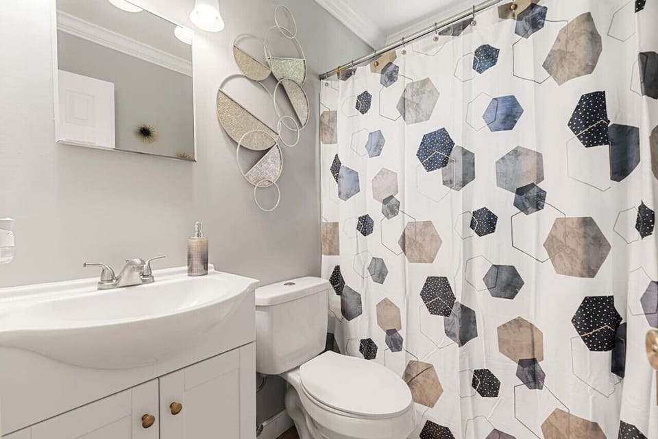Spacious full bathroom on the second floor with a shower and tub combo, sink, vanity, and toilet.