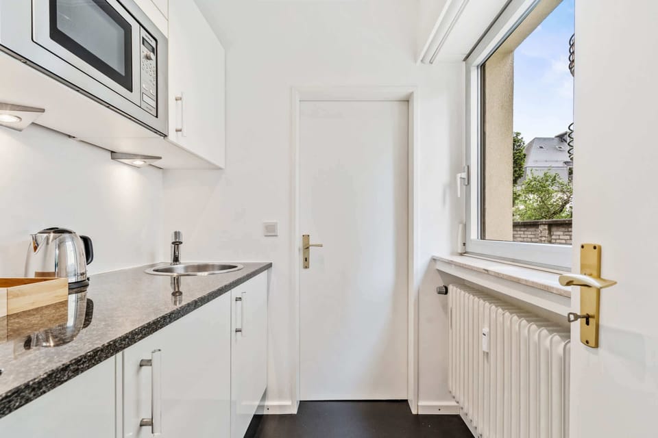 Bright and efficient kitchen equipped with essential appliances and plenty of counter space, ideal for preparing meals during your stay.