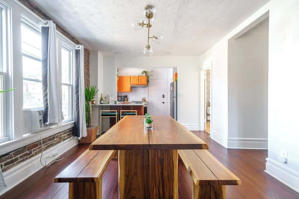 a spacious dining table for leisurely meals and a modern kitchen island for effortless meal prep,  a stylish long table and a spacious kitchen island, perfect for hosting memorable meals and fine dining