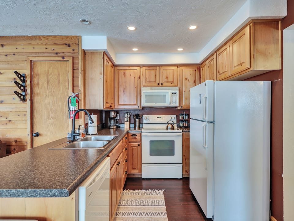 Fully loaded kitchen with, dishwasher, stainless steel sink, microwave, stove and oven