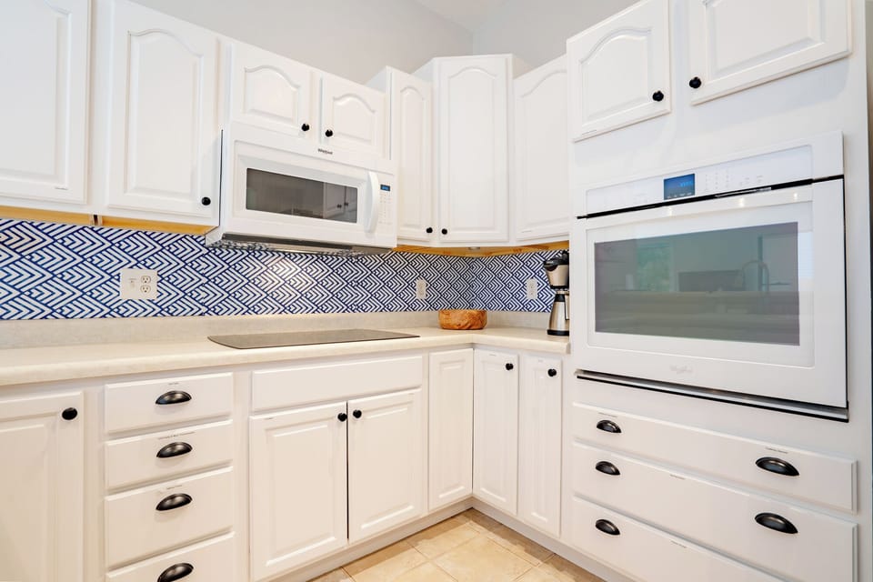 Kitchen is stocked with dishes, pans, glassware