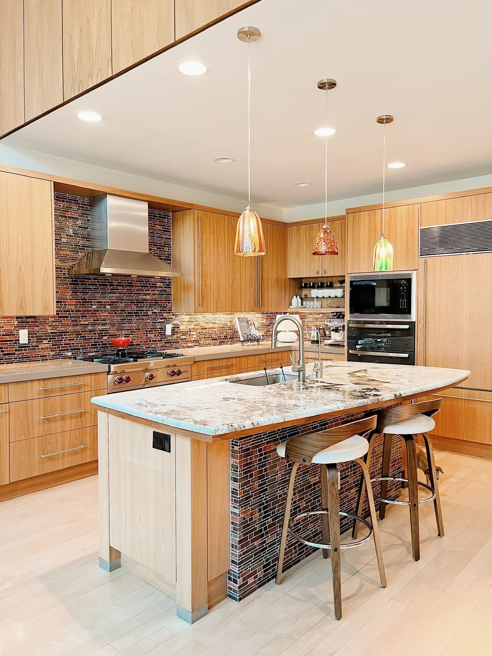 Jenn Air, Bosch, Sub Zero kitchen with Wolf double oven and chef's gas range.